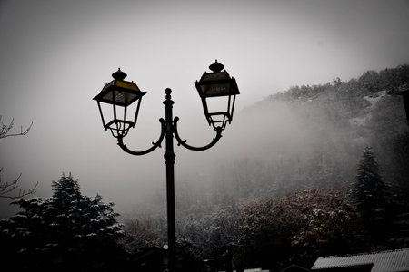 Lanterns on a foggy winter morning in the mountainsの写真素材