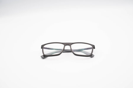 black glasses with a thick rim photographed against a white background, during a photo shoot in...
