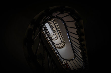 elliptical wooden stairwell of an old building in the streets of central Paris, the capital of...