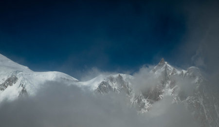 Snowy mountains in the clouds.の写真素材