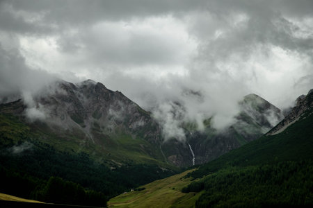 Mountain landscape with a waterfall in the clouds. Caucasus, Russiaの写真素材