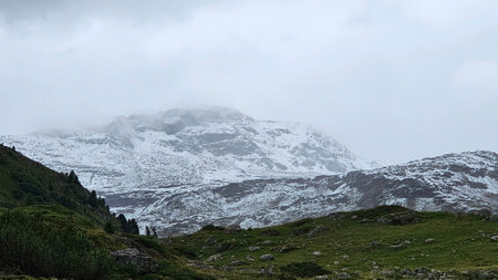 Mountains with snow and fog in the italian alps.