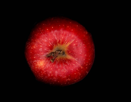 Red apple isolated on black background. Close-up. Top view.