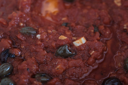 red tomato and olive sauce with spices typical of Italian cuisine for a Mediterranean pastaの写真素材