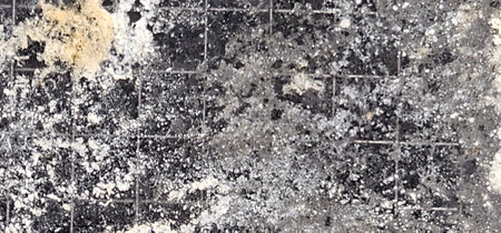 abstract background with black and white spots of paint on a gray ceramic tileの写真素材