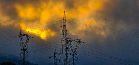 High-voltage power lines at sunset. electricity pylonsの写真素材