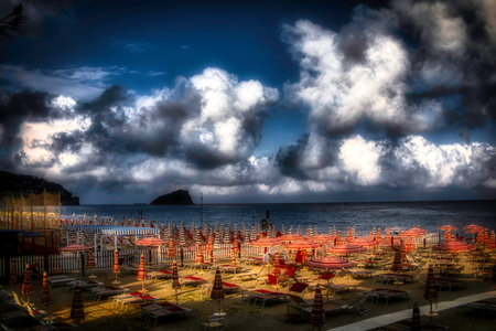 Sunset on the beach with umbrellas and sunbedsの写真素材