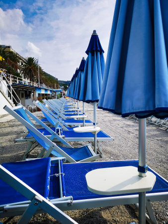 Beach chairs and umbrellas on a sunny day in the Mediterraneanの写真素材