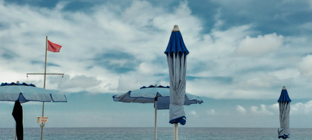 Umbrellas on the beach. Blue sky with white clouds.の写真素材