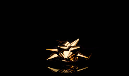 Golden Christmas ornament on a black background. Copy space for text.の写真素材