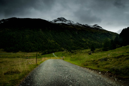 dirt mountain road in livigno, sondrio province on a gloomy summer dayの写真素材
