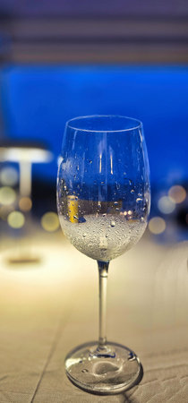 Wine glass on a table in a restaurant. Selective focus.