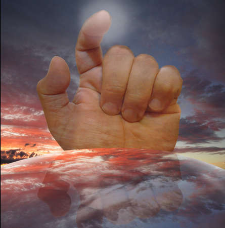 hand with index finger detached on a mirrored background celestial globe の写真素材