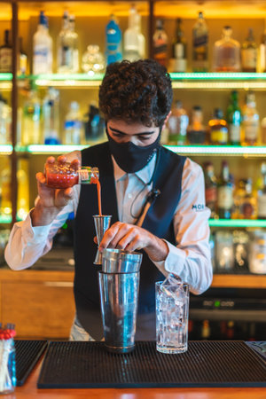 Barman making cocktail at night clubの写真素材