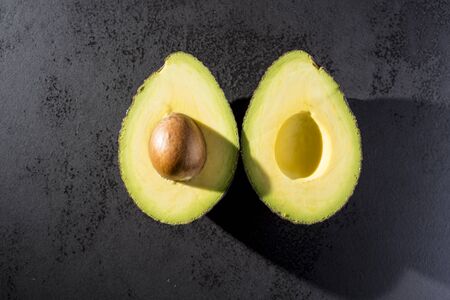 Avocado cut on black plate