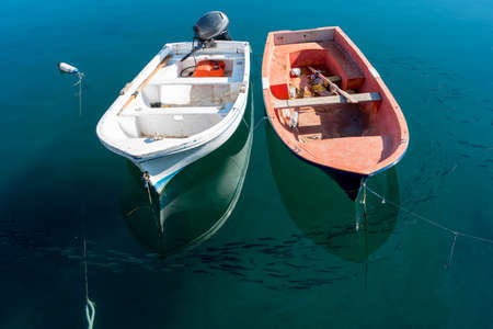 Old fishing boats moored in the harborの写真素材