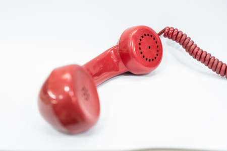 old red phone on green or white backgroundの写真素材