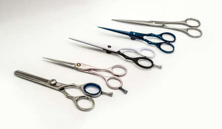 Barber and hairdresser scissors on white background