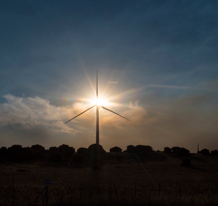 An image of wind turbine in the field at sunset.の写真素材