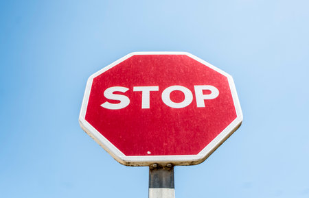 Stop sign on blue sky background. Road sign with stop symbol.の写真素材