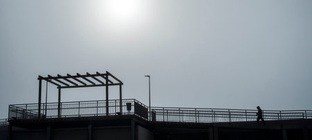 Silhouette of a man standing on the top of a building
