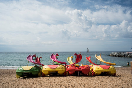 Colorful plastic kayaks on the beach of the Mediterranean Sea.の写真素材