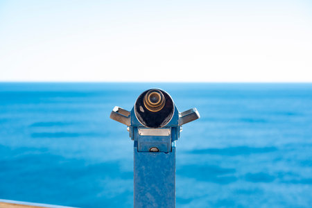 Coin operated binoculars on the background of the sea and blue skyの写真素材