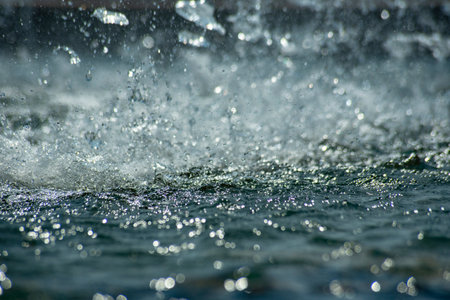 Splashes of water from the fountain in the city. Shallow depth of fieldの写真素材