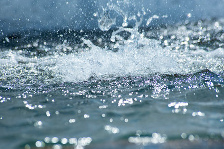 Splashes of water on the background of the fountain. Shallow depth of fieldの写真素材