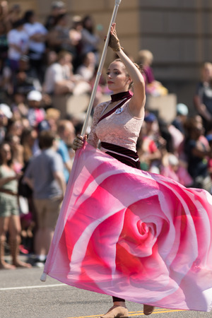 Washington, D.C., USA - April 14, 2018 Cheerleaders dancing with pink cherry flower flags in the 2018 National Cherry Blossom Paradeのeditorial素材