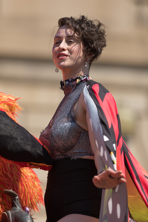 Washington, D.C., USA - April 14, 2018 A group of people wearing colorful outfits on top of a float going down the road in the 2018 National Cherry Blossom Paradeのeditorial素材