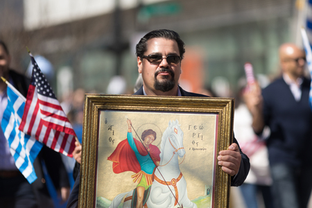 Chicago, Illinois, USA - April 29, 2018  Greek man carrying a painting of St. George from the Greek Orthodox Church during the Greek Independence  Day Paradeのeditorial素材