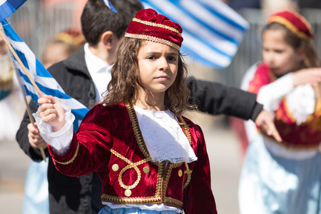 Chicago, Illinois, USA - April 29, 2018  Greek Children wearing traditional clothing and waving greek flags during the Greek Independence  Day Paradeのeditorial素材