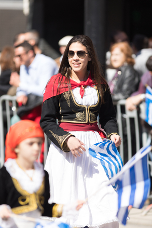 Chicago, Illinois, USA - April 29, 2018  Greek woman wearing traditional clothing waving the greek flag at the Greek Independence  Day Paradeのeditorial素材