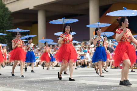 Indianapolis, Indiana, USA - May 26, 2018, Women wearing traditional chinese clothing and holding umbrellas from the Confucius Institute Indianapolis, from the IUPUI University  at the Indy 500 Paradeのeditorial素材