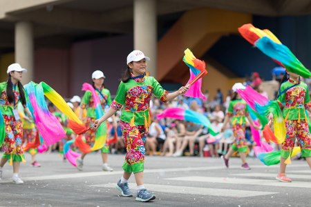 Indianapolis, Indiana, USA - May 26, 2018, Members of the Indianapolis Chinese Community Center, Inc.  Dancing while holding ribbons with their hands wearing traditional clothing at the Indy 500 Paradeのeditorial素材
