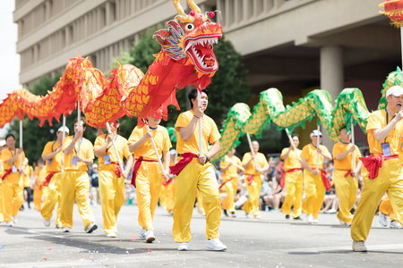 Indianapolis, Indiana, USA - May 26, 2018, Members of the Indianapolis Chinese Community Center, Inc. wearing traditional chinese clothing and holding dragons at the Indy 500 Paradeのeditorial素材