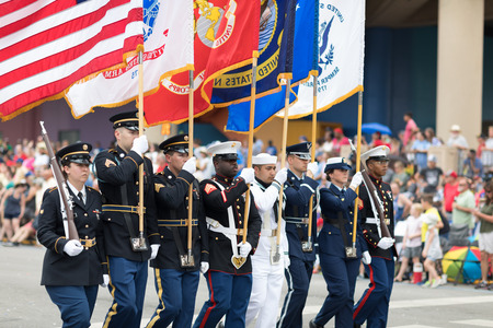 Indianapolis, Indiana, USA - May 26, 2018,  Members of the US Military carrying the American flag marching down the street during the Indy 500 Paradeのeditorial素材