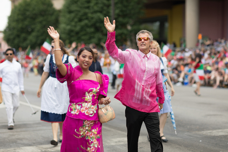 Indianapolis, Indiana, USA - May 26, 2018,  People from different countries with traditional clothing and carrying national flags at the Indy 500 Paradeのeditorial素材
