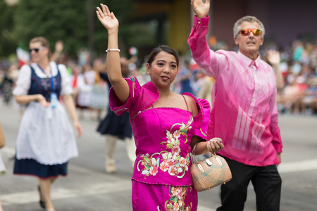 Indianapolis, Indiana, USA - May 26, 2018,  People from different countries with traditional clothing and carrying national flags at the Indy 500 Paradeのeditorial素材