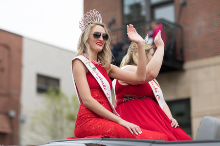 Holland, Michigan, USA - May 12, 2018 Beauty queens with ribbons that say Pulaski Queen on a car going down the road at the Muziek Parade, during the Tulip Time Festivalのeditorial素材
