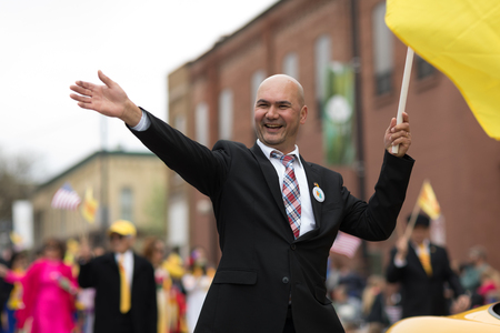 Holland, Michigan, USA - May 12, 2018 Members of Michigan Vietnamese American Community wearing traditional clothing and waving american and vietnamese flags at the Muziek Parade, during the Tulip Time Festivalのeditorial素材