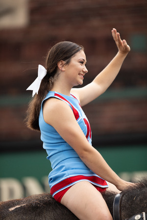 Peru, Indiana, USA - July 21, 2018 Young women riding elephants down the road at the Circus City Festival Paradeのeditorial素材