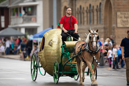 Peru, Indiana, USA - July 21, 2018 Horse pulling a wagon in the shape of an apple at the Circus City...