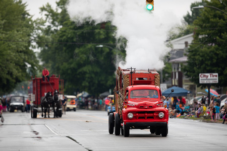 Peru, Indiana, USA - July 21, 2018 Old classic red turck creating steam going down the road at the Circus City Festival Paradeのeditorial素材