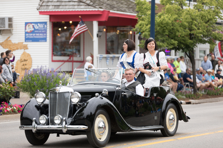 Frankenmuth, Michigan, USA - June 10, 2018 Past Bavarian Festival  Princess and court members wearing traditional german clothing going down the road on MG TF 1500 at the Bavarian Festival Parade.のeditorial素材