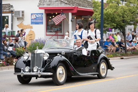 Frankenmuth, Michigan, USA - June 10, 2018 Past Bavarian Festival  Princess and court members wearing traditional german clothing going down the road on MG TF 1500 at the Bavarian Festival Parade.のeditorial素材