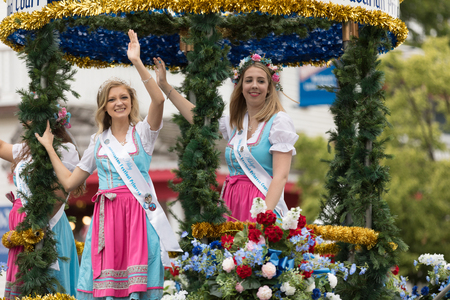 Frankenmuth, Michigan, USA - June 10, 2018 The Bravarian Princess and Court ridding on a float surrounded by flowers and wearing traditional german clothing at the Bavarian Festival Parade.のeditorial素材