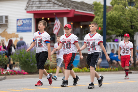 Frankenmuth, Michigan, USA - June 10, 2018 Members of the Muth Youth Football and Cheer going down the road at the Bavarian Festival Parade.のeditorial素材