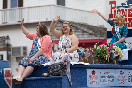 Frankenmuth, Michigan, USA - June 10, 2018 The Michigan Sugar Queen, on a float with flowers going down the road at the Bavarian Festival Parade.のeditorial素材